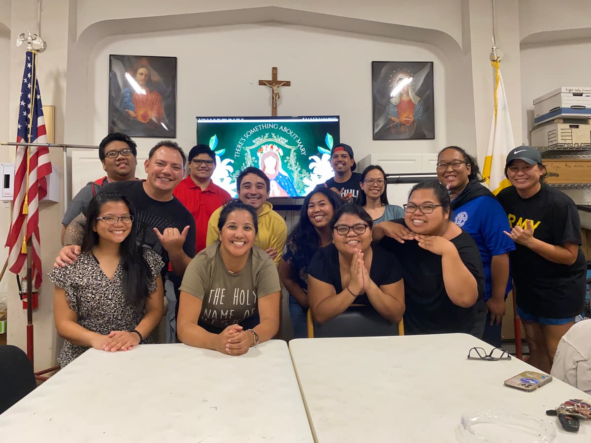 Group of young Catholic adults smiling brightly after a Strive ministry gathering
